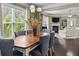 Open-concept dining area adjacent to a living room featuring a large wooden table with seating at 1850 Overlook Springs Ln, Cumming, GA 30040