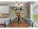 Well-lit dining area with a large wooden table, seating for six, and a charming decorative arrangement at 1850 Overlook Springs Ln, Cumming, GA 30040