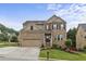 Charming two-story brick home with well-manicured lawn and attached two car garage at 1850 Overlook Springs Ln, Cumming, GA 30040