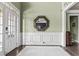 Inviting foyer with a white front door, decorative wainscoting, and an ornate mirror, leading to other rooms at 1850 Overlook Springs Ln, Cumming, GA 30040