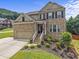 Charming two-story brick home featuring a manicured front yard and inviting entryway at 1850 Overlook Springs Ln, Cumming, GA 30040