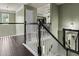 View of the upstairs hallway with wainscotting, hardwood floors, and view to lower level at 1850 Overlook Springs Ln, Cumming, GA 30040
