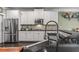 Modern kitchen with stainless steel appliances, white cabinets, and sleek black countertops at 1850 Overlook Springs Ln, Cumming, GA 30040