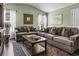 Inviting living room features a large couch, patterned rug and a large TV at 1850 Overlook Springs Ln, Cumming, GA 30040