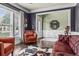 Comfortable living area with classic furniture, natural light, and views into the entryway at 1850 Overlook Springs Ln, Cumming, GA 30040