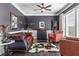 Stylish living room with dark grey walls, wood floors, and sophisticated furnishings at 1850 Overlook Springs Ln, Cumming, GA 30040