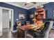 Office space featuring a large wooden desk, leather chairs, and navy blue walls at 1850 Overlook Springs Ln, Cumming, GA 30040