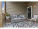 Cozy covered patio with a comfortable seating area, a patterned rug and wood flooring at 1850 Overlook Springs Ln, Cumming, GA 30040