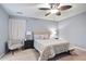 The bedroom features a modern ceiling fan, light gray walls, neutral carpet, and side tables with lamps at 189 Timber Creek Ln, Marietta, GA 30060