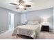Bedroom features a modern ceiling fan, light gray walls, neutral carpet, and a door to the ensuite bath at 189 Timber Creek Ln, Marietta, GA 30060