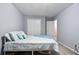 This bedroom includes a closet, light gray walls, neutral carpet, and a patterned duvet at 189 Timber Creek Ln, Marietta, GA 30060