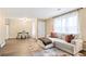 Open concept living room and dining area featuring sleek floors, modern furnishings, and ample natural light at 189 Timber Creek Ln, Marietta, GA 30060