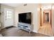 Open-concept room with sleek floors, a modern TV stand, and a hallway at 189 Timber Creek Ln, Marietta, GA 30060