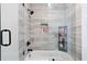 This shower features gray plank tile, a niche for toiletries, and a modern black shower head and handle at 189 Timber Creek Ln, Marietta, GA 30060