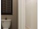 Powder room with toilet and artwork and a view into the walk in closet at 2340 Treaty Ln, Douglasville, GA 30135