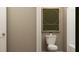 Stylish half-bathroom features a toilet with modern wall art, creating a simple yet elegant space at 2340 Treaty Ln, Douglasville, GA 30135