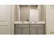 Elegant double vanity bathroom featuring gray cabinets, a large mirror, and white countertops at 2340 Treaty Ln, Douglasville, GA 30135