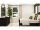Modern bedroom with a mirror and a large plant for natural decor at 2340 Treaty Ln, Douglasville, GA 30135