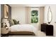 Serene bedroom with a plush bed, giraffe artwork, dresser, and natural light from a large window at 2340 Treaty Ln, Douglasville, GA 30135