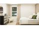 Bright bedroom with a plush bed, modern accents, and a cozy chair by the window at 2340 Treaty Ln, Douglasville, GA 30135