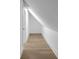 Cozy attic space with slanted ceilings, neutral walls, and hardwood flooring at 2631 Sardis Way, Buford, GA 30519