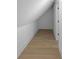 Charming attic space with wood flooring, white walls, offering additional storage or living area at 2631 Sardis Way, Buford, GA 30519
