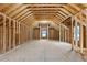 Unfinished attic space with exposed wood framing and a window at 2631 Sardis Way, Buford, GA 30519