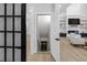 Stairwell leading to the basement showcases an open doorway and is naturally lit by an inviting light-filled living space at 2631 Sardis Way, Buford, GA 30519