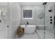 Bathroom featuring a modern tub, a walk-in shower, and sleek finishes at 2631 Sardis Way, Buford, GA 30519