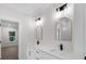 Bathroom with dual sinks, gold-trimmed mirrors, and elegant lighting at 2631 Sardis Way, Buford, GA 30519
