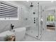 Modern bathroom featuring a glass enclosed shower and a standalone bathtub with marble accents at 2631 Sardis Way, Buford, GA 30519