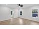 Sunlit bedroom with hardwood floors, large windows, and neutral walls at 2631 Sardis Way, Buford, GA 30519
