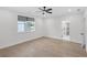 Well-lit bedroom featuring hardwood floors, modern ceiling fan, natural light, and neutral color palette at 2631 Sardis Way, Buford, GA 30519