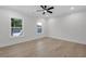 Bright bedroom features hardwood floors, two windows, ceiling fan and recessed lighting at 2631 Sardis Way, Buford, GA 30519