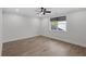 Spacious bedroom featuring hardwood floors, a ceiling fan, and bright natural light at 2631 Sardis Way, Buford, GA 30519