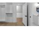 Walk-in closet featuring open shelving, hardwood floors, and a peek at the bathroom at 2631 Sardis Way, Buford, GA 30519