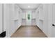 Walk-in closet with custom shelving, hardwood floors, and a window for natural light at 2631 Sardis Way, Buford, GA 30519