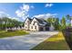 Spacious driveway leads to a charming two-story home with lush green lawn, offering ample parking and curb appeal at 2631 Sardis Way, Buford, GA 30519