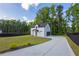 Long driveway leads to a well-maintained home, surrounded by lush greenery and complemented by a manicured lawn at 2631 Sardis Way, Buford, GA 30519