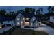 Stunning two-story home with a modern design, lush landscaping, and a long driveway leading to a three-car garage at 2631 Sardis Way, Buford, GA 30519