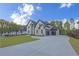 Beautiful home with a spacious driveway, manicured lawn, and lush landscaping at 2631 Sardis Way, Buford, GA 30519