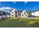 Charming two-story home with landscaped yard, complemented by a lush green lawn and inviting entryway on a sunny day at 2631 Sardis Way, Buford, GA 30519