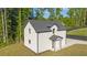 Exterior view of guest house with well-kept lawn, black trim and white brick at 2631 Sardis Way, Buford, GA 30519