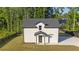 Exterior view of guest house with well-kept lawn, black trim and white brick at 2631 Sardis Way, Buford, GA 30519