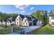 Beautiful front exterior featuring a long driveway, three-car garage, and manicured lawn at 2631 Sardis Way, Buford, GA 30519