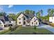 Striking front exterior featuring a circular driveway, manicured lawn, and black fence at 2631 Sardis Way, Buford, GA 30519