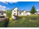 Lush front yard of a two-story home, complemented by a well-manicured lawn, and featuring a charming landscape at 2631 Sardis Way, Buford, GA 30519