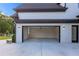 Open garage with ample space and natural light, complemented by a well-maintained driveway and landscaping at 2631 Sardis Way, Buford, GA 30519