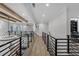 Open hallway featuring iron railings, hardwood floors, and views of the living spaces at 2631 Sardis Way, Buford, GA 30519