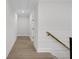 Bright hallway features hardwood floors and white walls, offering a clean, modern aesthetic at 2631 Sardis Way, Buford, GA 30519